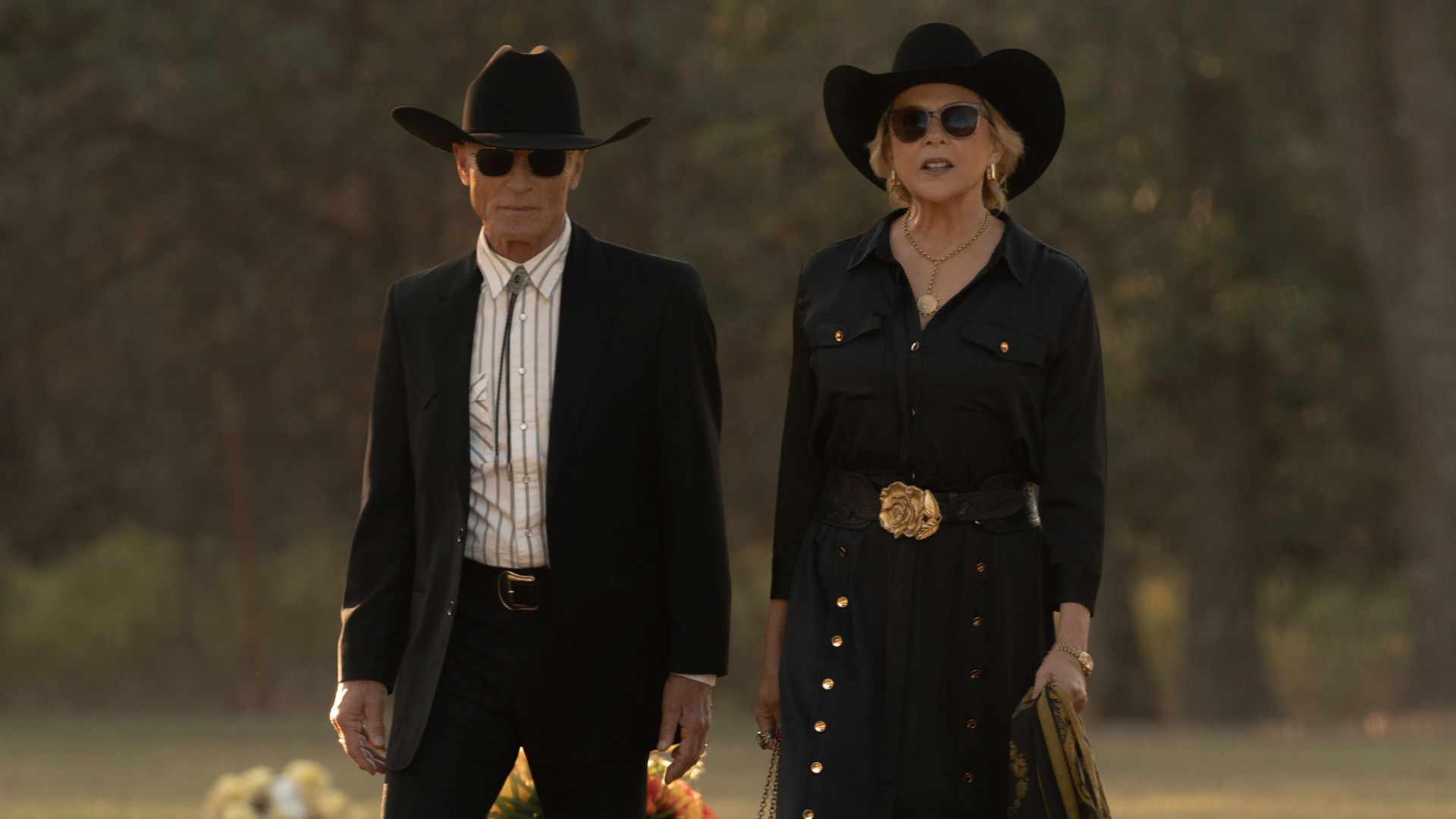 Everett and Beulah walk through a graveyard in funeral attire