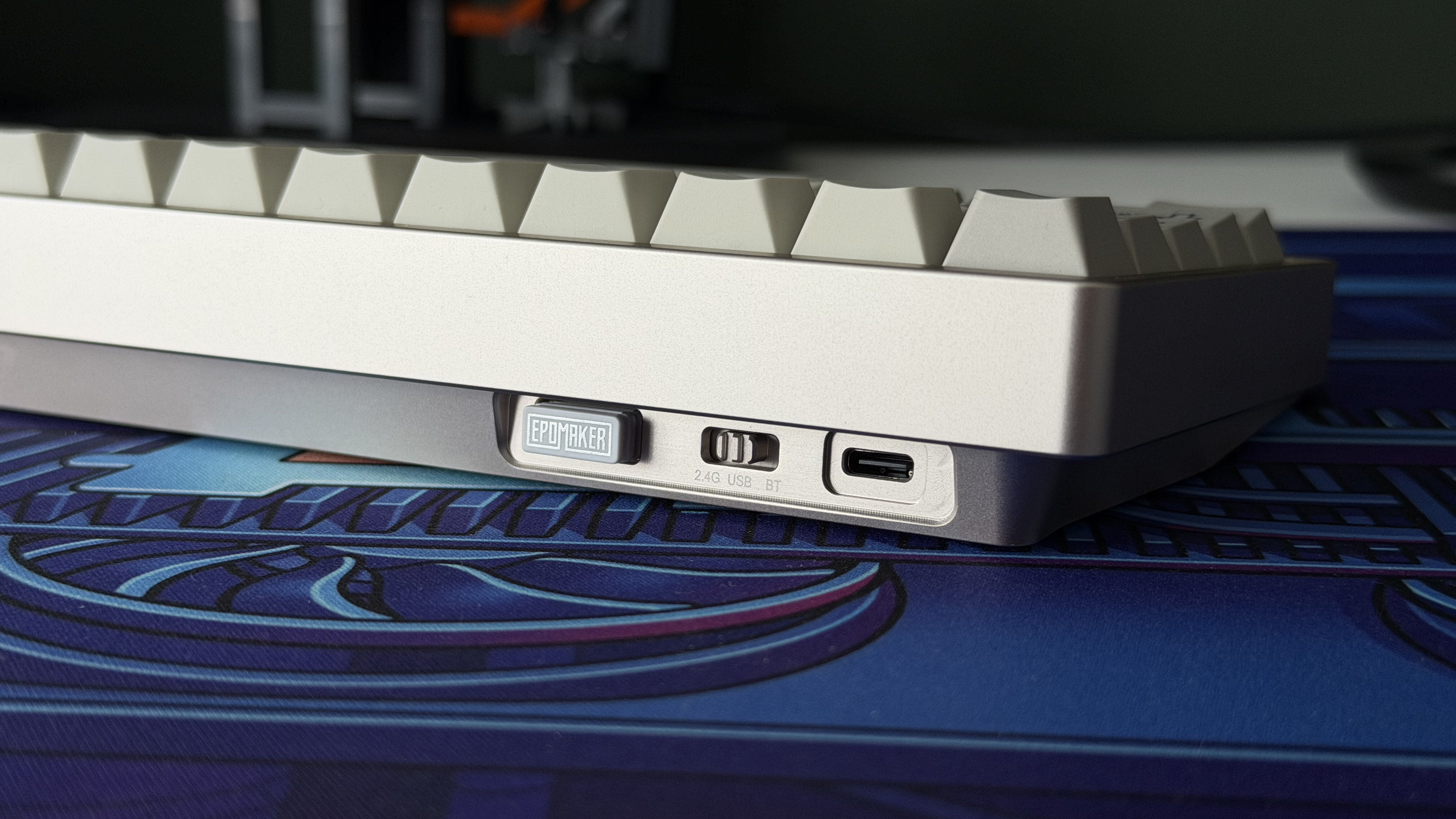 A closeup of the rear corner of the Epomaker 65, showing its 2.4GHz dongle, mode switch and USB-C port.