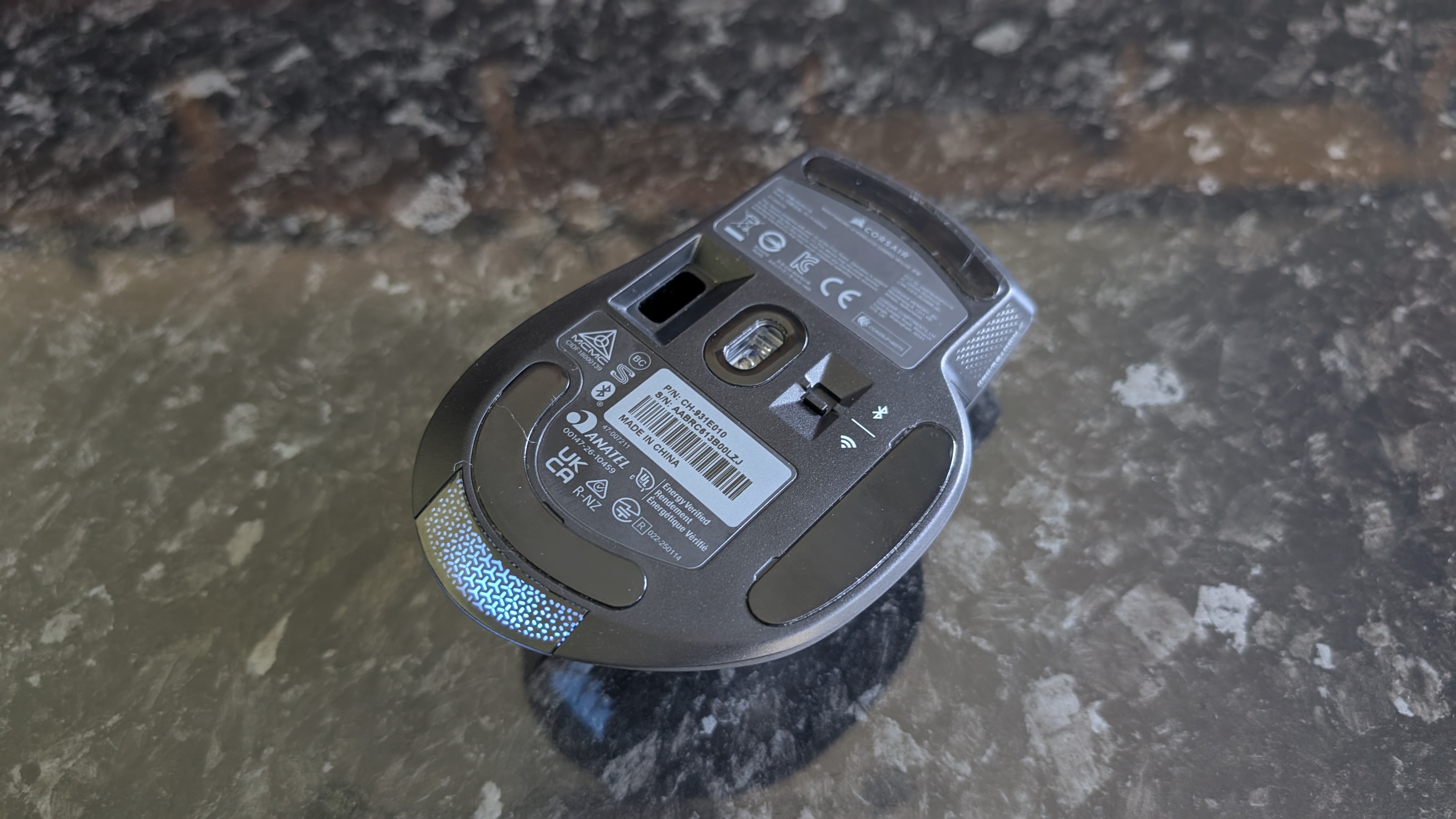 The Corsair Nightsword V2 Wireless gaming mouse pictured on a black marble worktop.