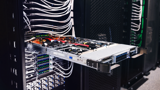 An Nvidia GB200 server rack in a data center with one rack open and exposed.