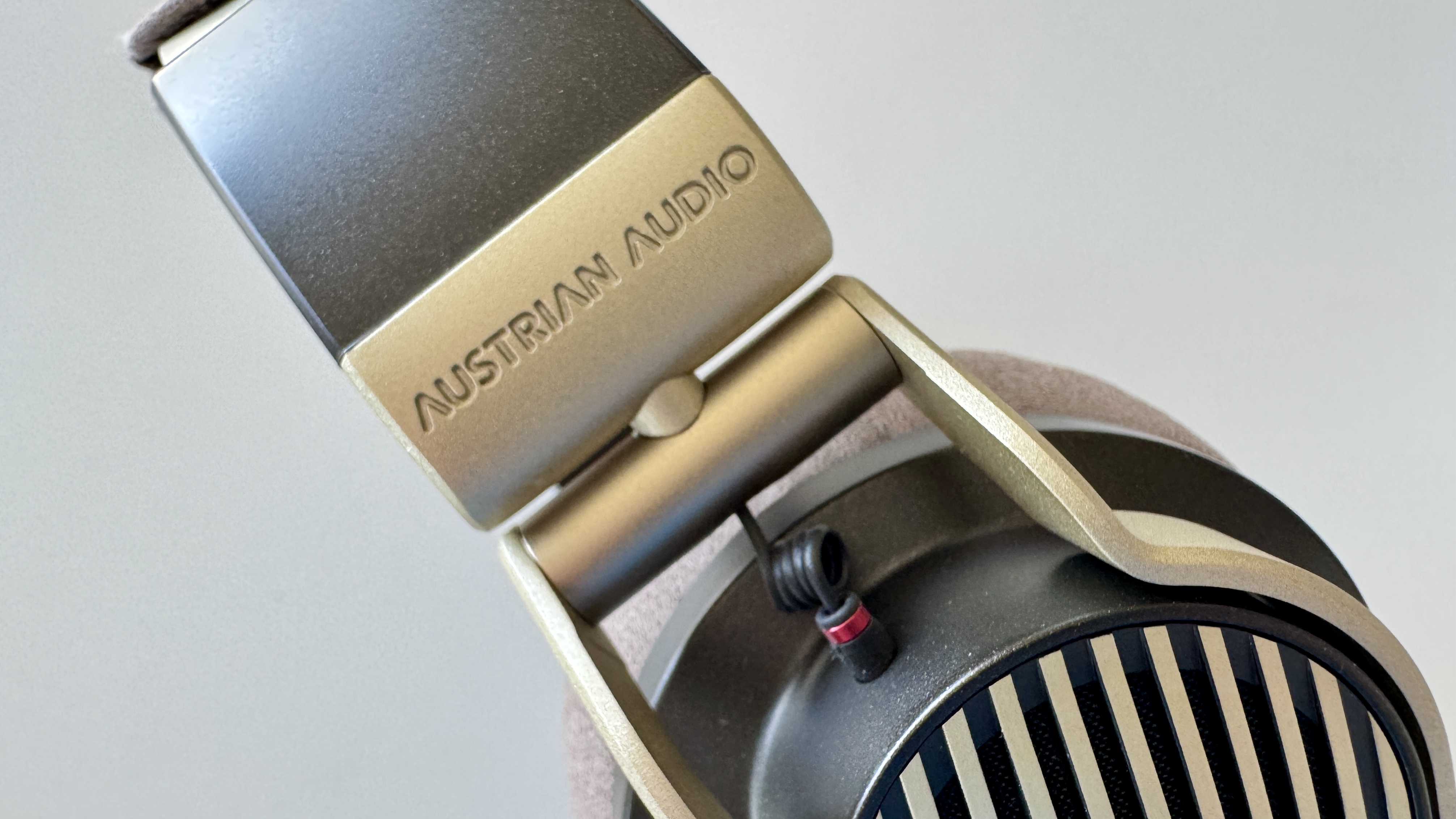 Austrian Audio The Arranger open-backed over-ear headphones side panels on a white surface.