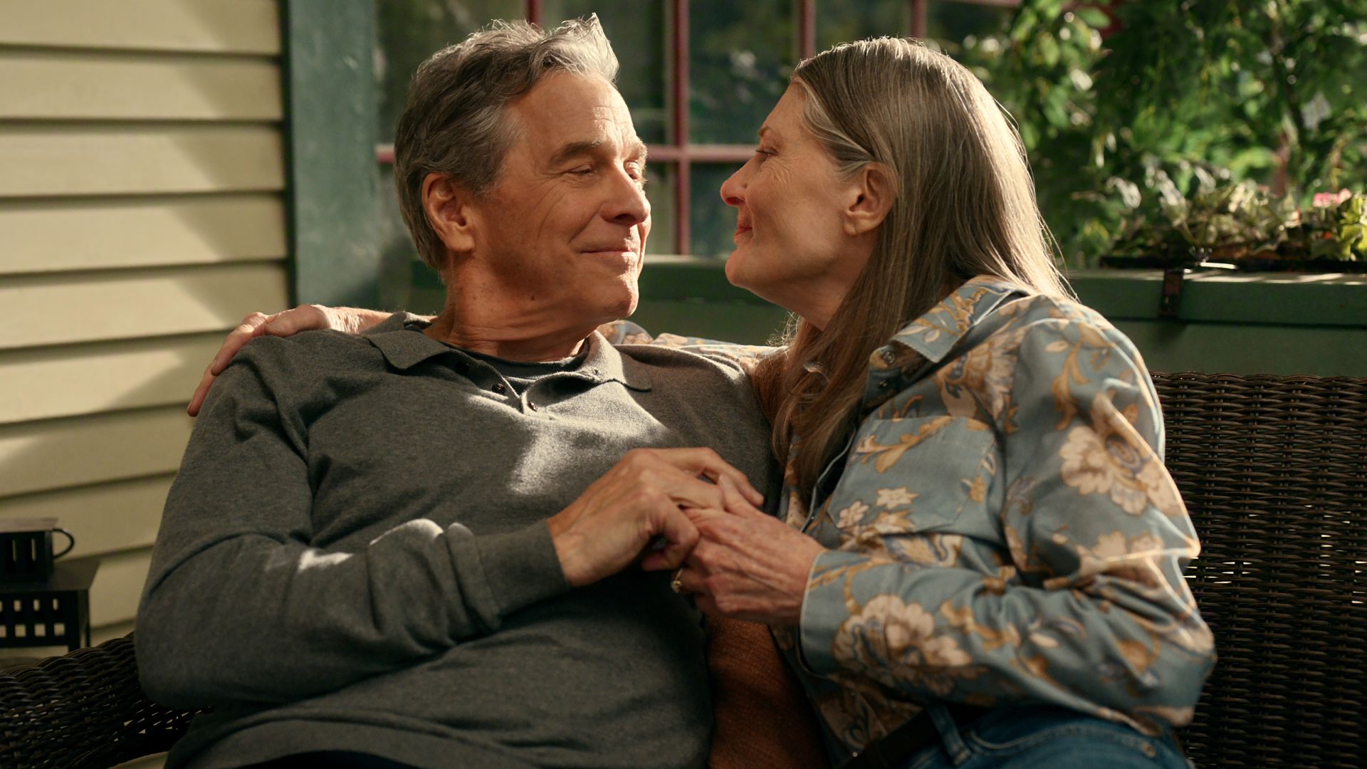 Doc and Hope embrace on their porch bench