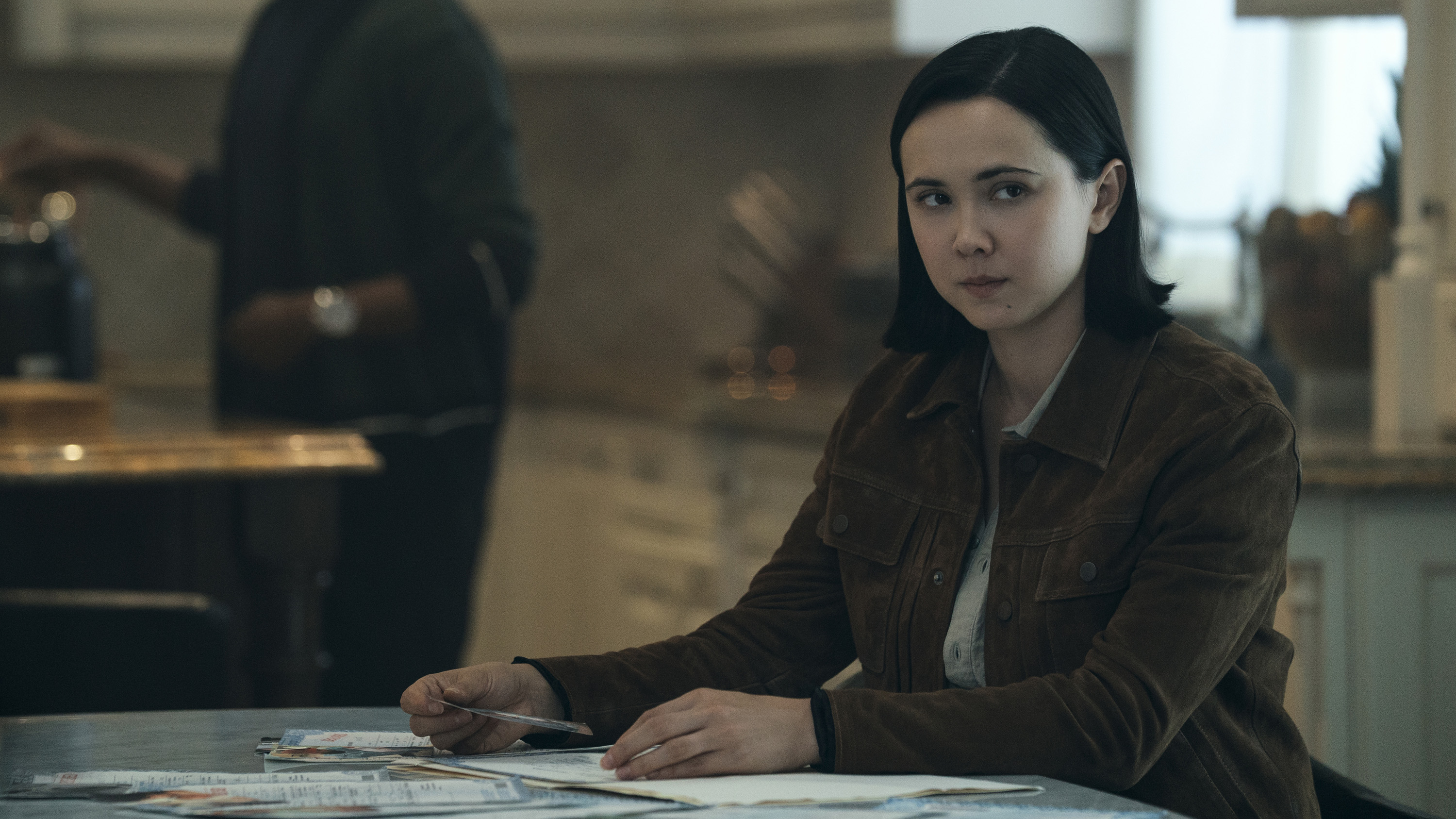 Jordan Li's female form sitting at a table in Gen V season 2
