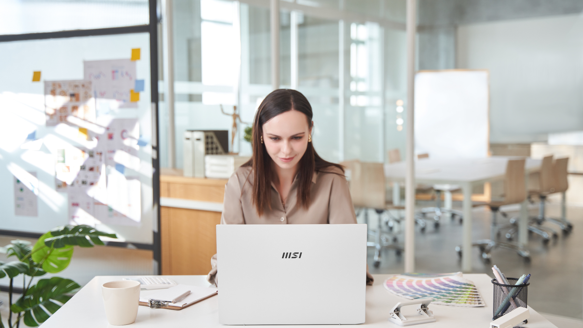 MSI promotional photo of a woman using a Prestige A16 AI+ laptop