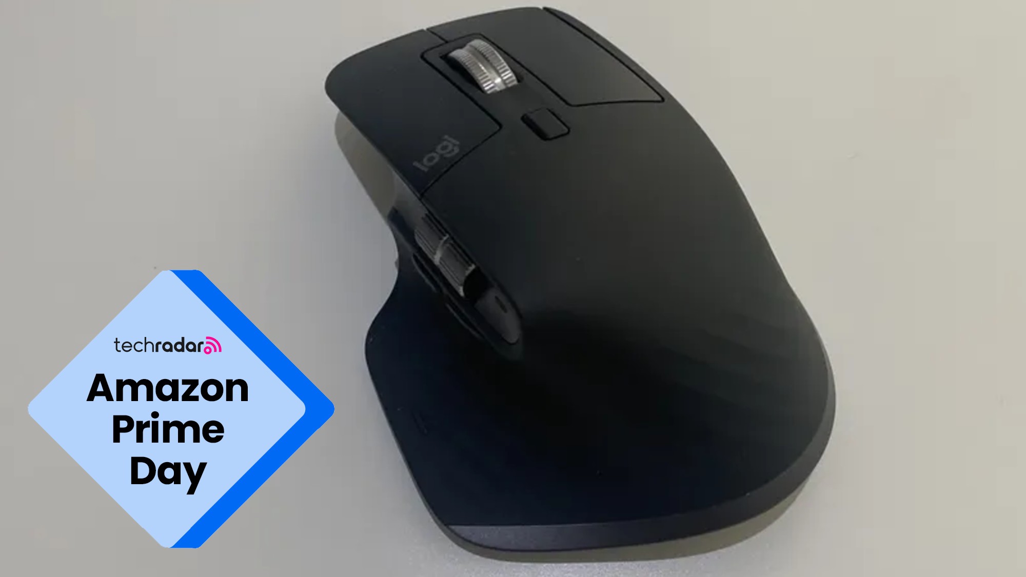 The Logitech Master MX 3S on a desk during our review, next to a TechRadar badge that reads 'Amazon Prime Day'