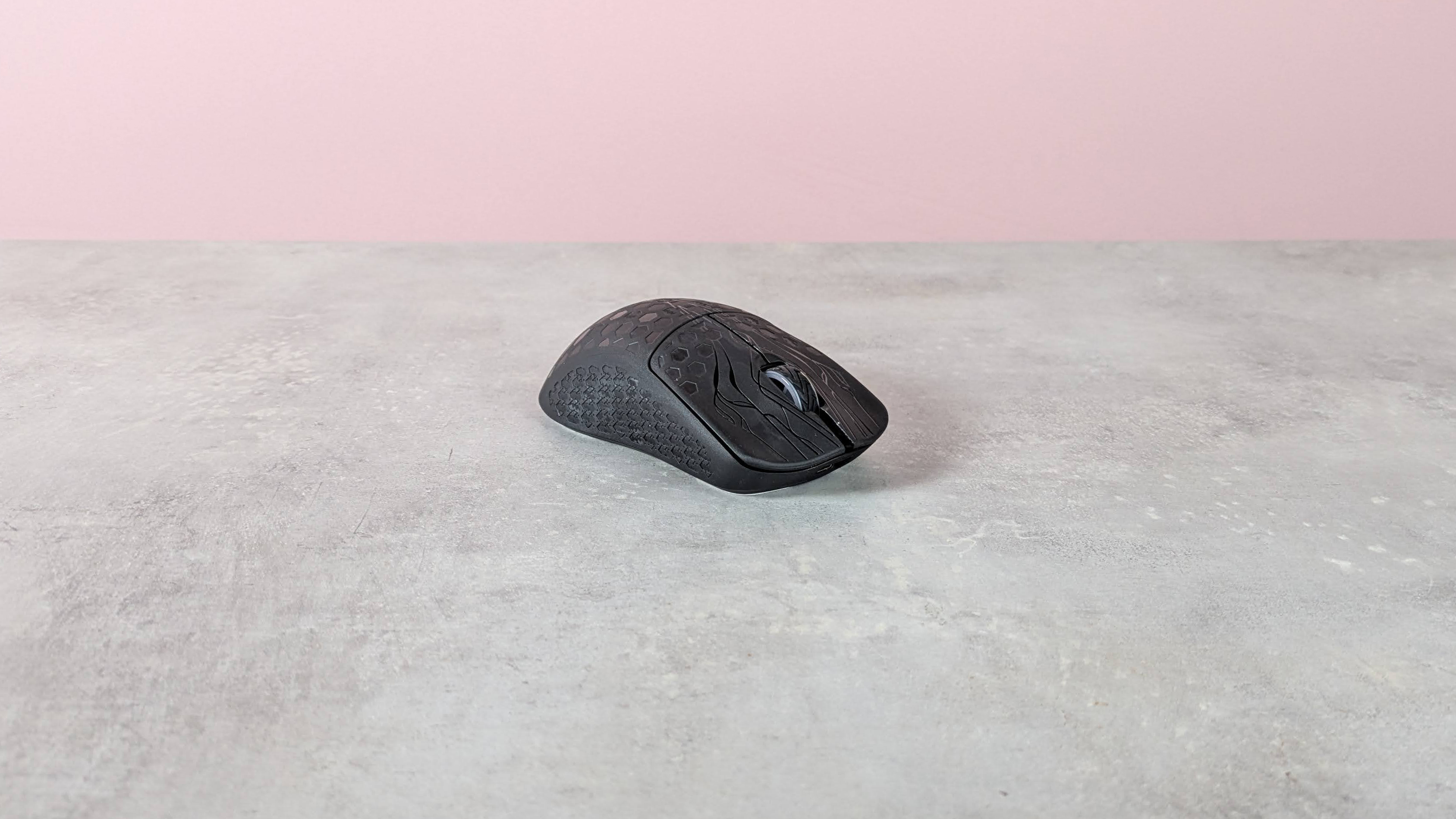 Three-quarter view of Keychron G5 on a desk with pink wall in background