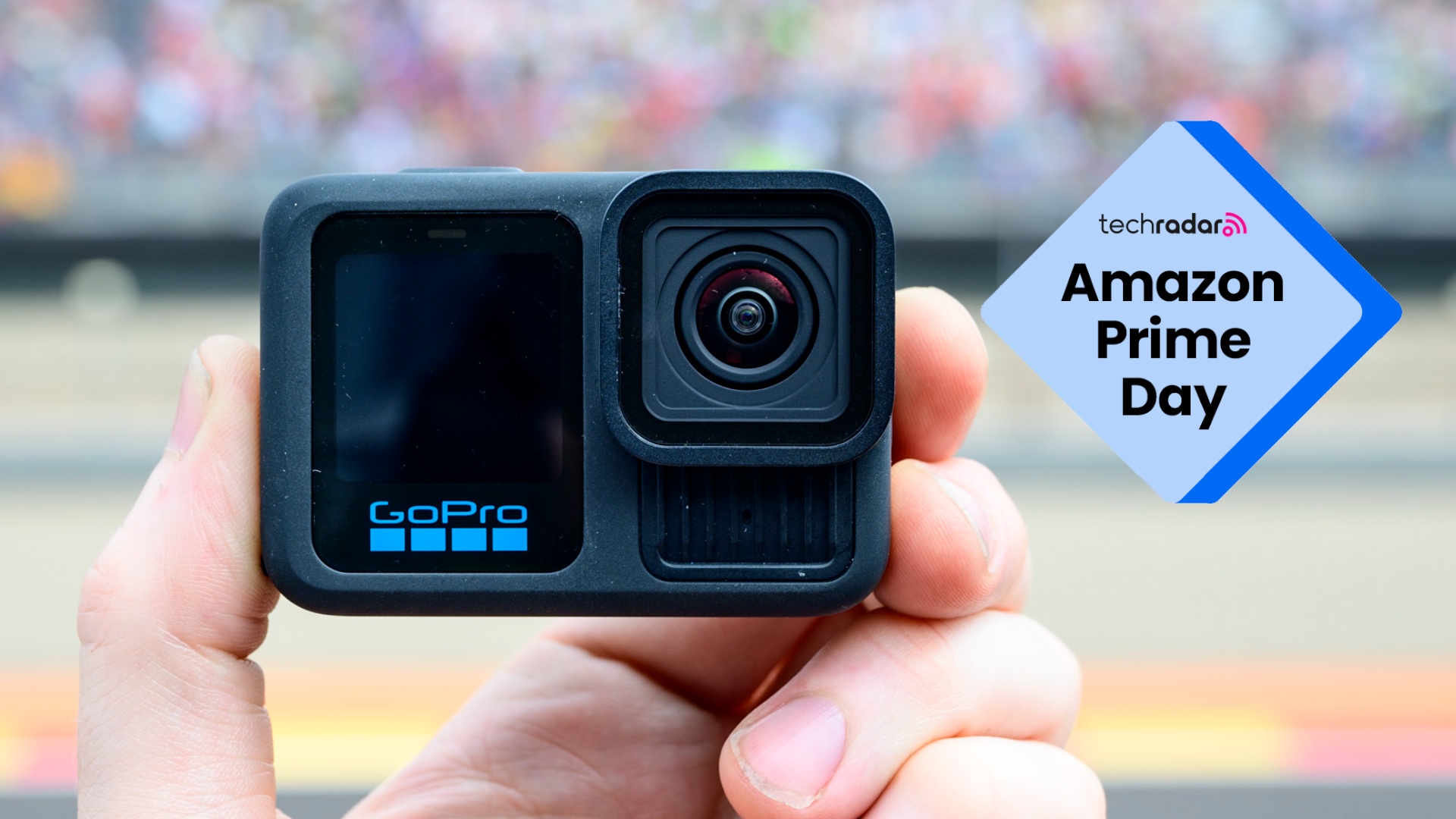 Man's hand holding the GoPro Hero 13 Black action camera, with a TechRadar 'Amazon Prime Day' logo next to it superimposed
